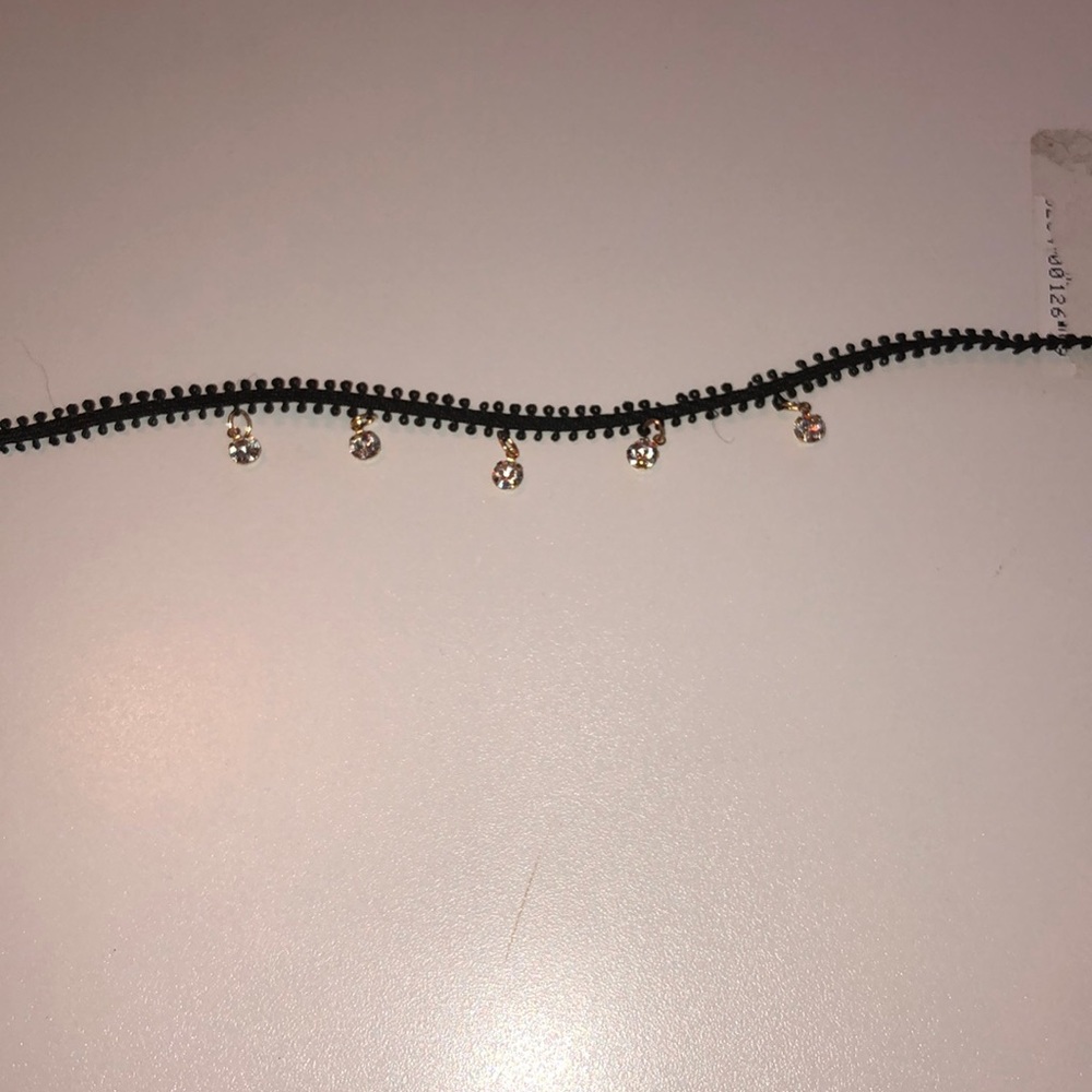 This is a black choker with jewels